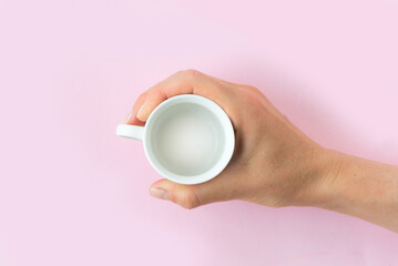 A woman's hand holds a coffee mug. Close-up of letterhead for design