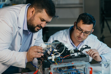 Two scientists are working on the development of a new device