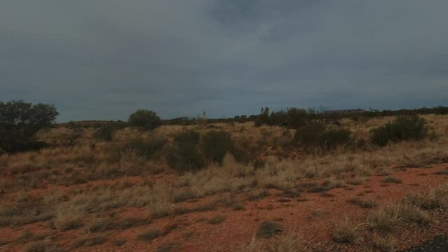 The shot from a window of a car as it drives through the desert in outback Australia