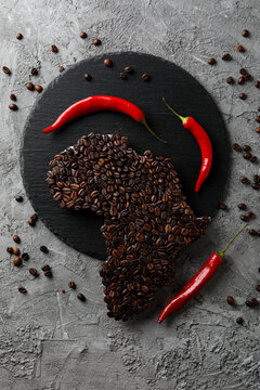 African continent made of coffee beans on gray textured background