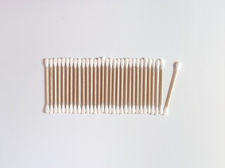 Bamboo cotton swabs on a white background. a row of sticks. Top view