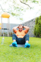 Fototapeta premium Young latin guy exercising on the ground in the park