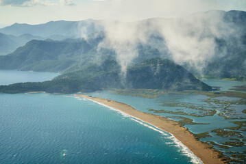 Panormic view beautiful landscape of sandy empty beach Iztuzu in Turkey with mountain range in clouds