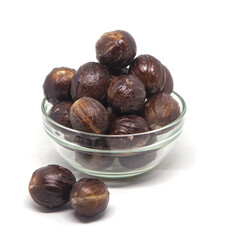 Sri Lankan nutmeg with shell spice. Authentic nutmeg with shell spice on a solid white background.