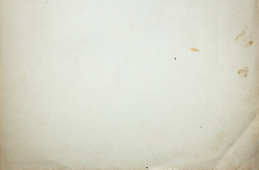 The texture of old cardboard paper with a crumpled corner and spots