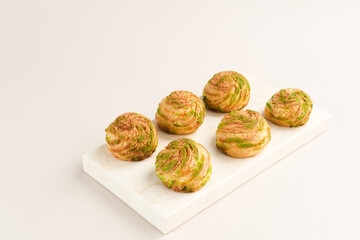 Choux pastry contains butter, water, flour, and eggs. Choux pastries are sometimes filled with cream to make cream puffs. 
