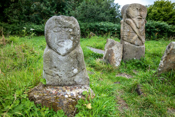 This is a bronze age stone carviing with two faces,called Janus, located In Caldragh Cemetery on Boa Island, Lower Lough Erne. Northern Ireland