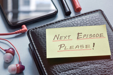 Handwritten note Next Episode Please! on keyboard. Binge-watching shows and one more episode syndrome concept.