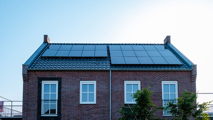 Newly build houses with solar panels attached on the roof against a sunny sky Close up of a new...