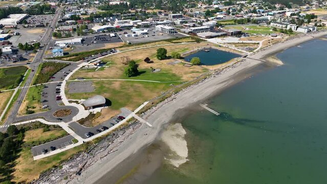 Aerial view of Windjammer Park in Oak Harbor, WA with the bustling city off in the distance.