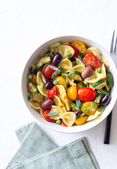 Pasta farfalle with tomatoes, zucchini, peas, Kalamata olives and sage. Healthy eating. Vegetarian food.