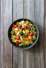 Pasta farfalle with tomatoes, zucchini, peas, Kalamata olives and sage. Healthy eating. Vegetarian food.