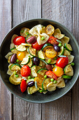 Pasta farfalle with tomatoes, zucchini, peas, Kalamata olives and sage. Healthy eating. Vegetarian food.