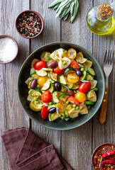 Pasta farfalle with tomatoes, zucchini, peas, Kalamata olives and sage. Healthy eating. Vegetarian food.