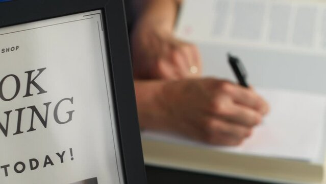 Unrecognizable author signing autographs at a book launch