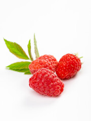 Isolated berries. Bunch of raspberry fruits with leaves isolated on white background with clipping path