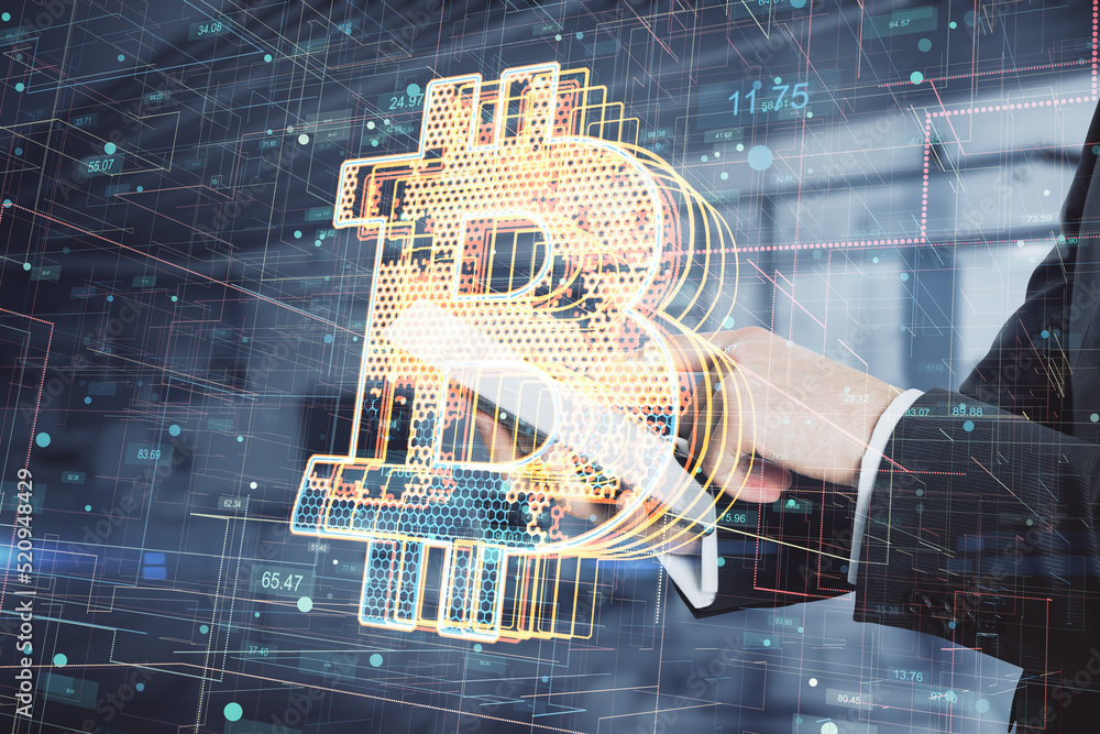 Poster close up of businessman hands using tablet with creative glowing bitcoin hologram on blurry office i