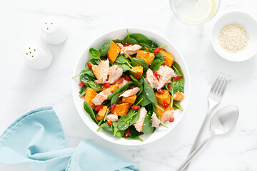 Spinach, salmon and sweetpotato festive thansgiving salad with paprika, top view