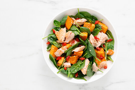 Spinach, salmon and sweetpotato festive thansgiving salad with paprika, top view