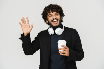 Young adult indian handsome curly man waving with coffee