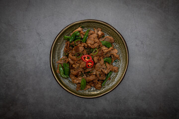 Stir-fried meat on a plate.