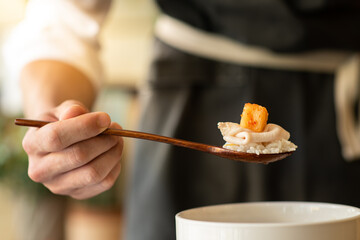 Kimchi and meat on a spoon.