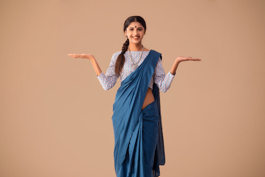 Portrait of a woman model gesturing against plain background