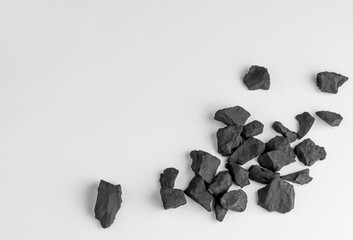 shungite stones on a white background with a copy space