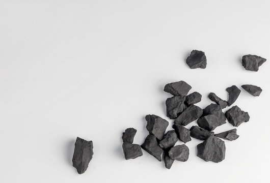 shungite stones on a white background with a copy space