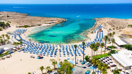 Deurstickers Aerial bird's eye view of Vathia Gonia beach, Ayia Napa, Famagusta, Cyprus. Landmark tourist attraction rocky bay with golden sand, sunbeds, sea restaurants in Agia Napa on summer holidays from above © f8grapher