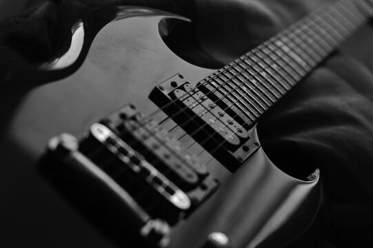 Low key image of an electric guitar in black and white