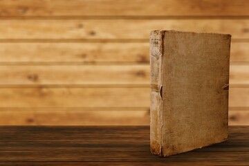 A retro old book on a wooden table.