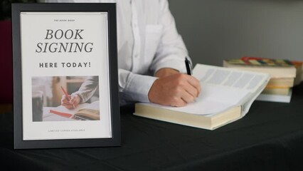 Male author signing books at a book launch