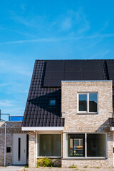 Newly build houses with solar panels attached on the roof against a sunny sky Close up of a new...