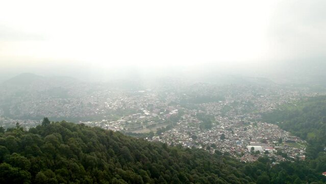 drone shot of mexico city from south forest park during a very polluted hour