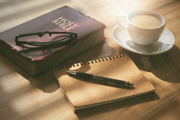 Pray and study the Bible in the morning in the warm sunshine on a bright day. with a cup of coffee...