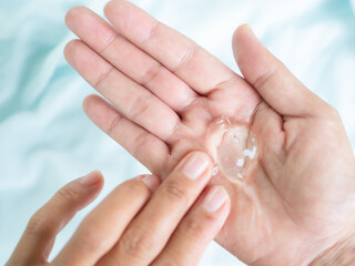 Aloe Gel face skin care cream.aloe vera gel on palm up woman with blur blue fabric...