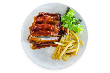 Top view of Barbecue Pork Ribs with french fries, focus selective