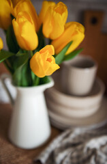 Obraz na płótnie Canvas Beautiful tulip flowers on table at kitchen