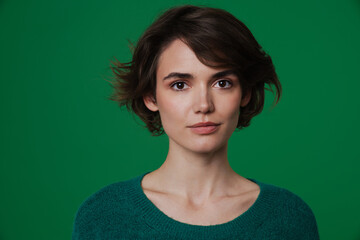 Fototapeta premium Young white woman wearing sweater posing and looking at camera