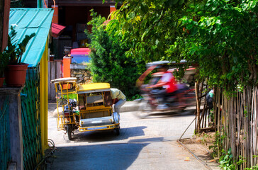 Obraz premium Typical Tricycle Traffic in Puerto Galera on Mindoro, Philippines