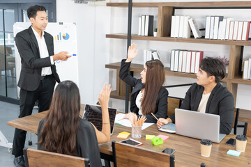 Business presentation. project manager pointing at desktop presenting statistical data, briefing diverse group of employees. demonstrates statistics.