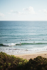 Shot of surfers surfing at the coast of Algarve, Portugal. Beautiful beach.