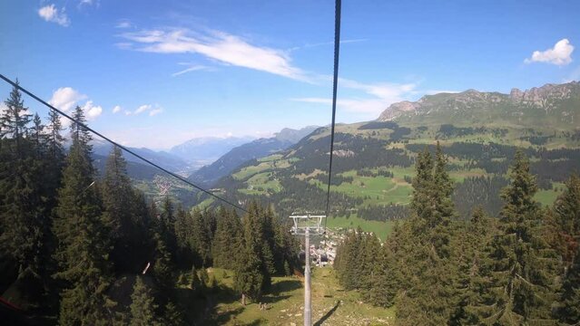 Cable car ride in canton Grisons Churwalden. View from a cable car on the beautiful nature in Switzerland. The funicular descends into the valley