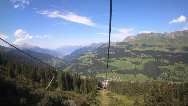 Cable car ride in the canton of Grisons. View of the beautiful nature in Switzerland from a gondola lift Heidb&uuml;el Bahn