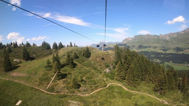 Ride on a cable car in the canton of Grisons. Cable car masts and beautiful landscape