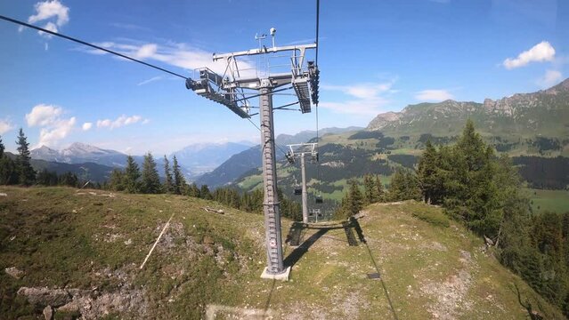Gondola ride in the canton of Grisons Churwalden. View from a gondola cableway approaching two masts