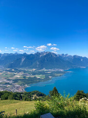 Fototapeta na wymiar Montreux, Switzerland: 01-08-2022: Panorama of the Switzerland Alpine mountains. Ridges, peaks and lake are visible in the background. Beautiful view in the French Canton.