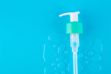 Drops of moisturized serum, essential with white dispenser on blue background. Flatlay close up. organic gentle facial skincare, сleansing micellar water product cleanser