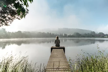 Fototapete Rund Pier Calm misty morning relaxation by pond.Sitting woman in countryside.Intended female mysterious atmosphere. Spring foggy nature.Silence.Woman feeling freedom,enjoying vacation.No stress,calm mind,relax  © Eva